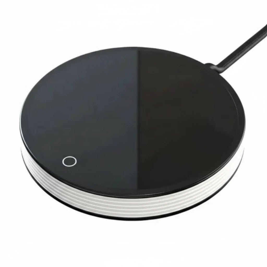 Black circular charging pad with a white base on a white background